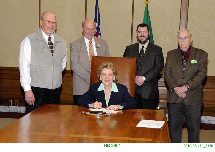 The signing of HB 2861.  Pictured from left to right: Roger Flygare, Rick Jensen, Governor Christine Gregoire, Dylan Doty, and Gordon Walgren